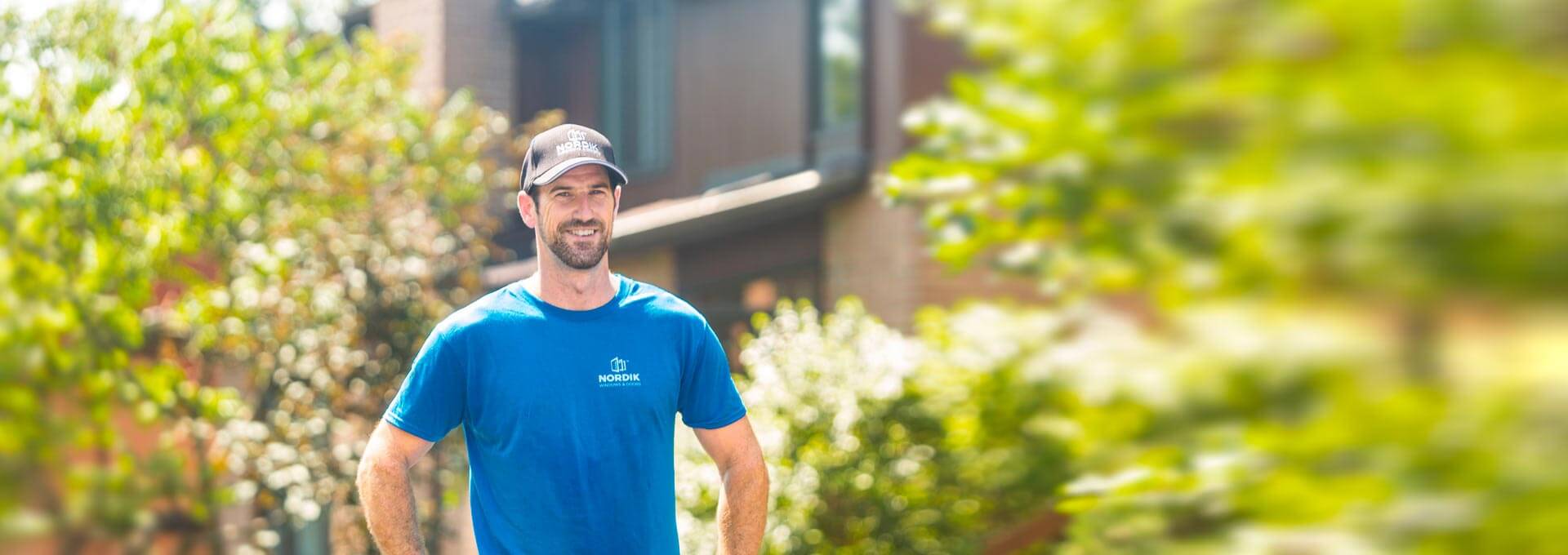 A Nordik window installer poses in front of a Whitby, Ontario home.