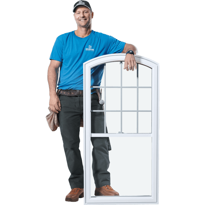 A Nordik installer stands beside an assembled PVC window.